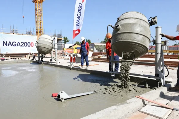 NAGA2000 technology enhancing concrete installation at a bustling construction site.